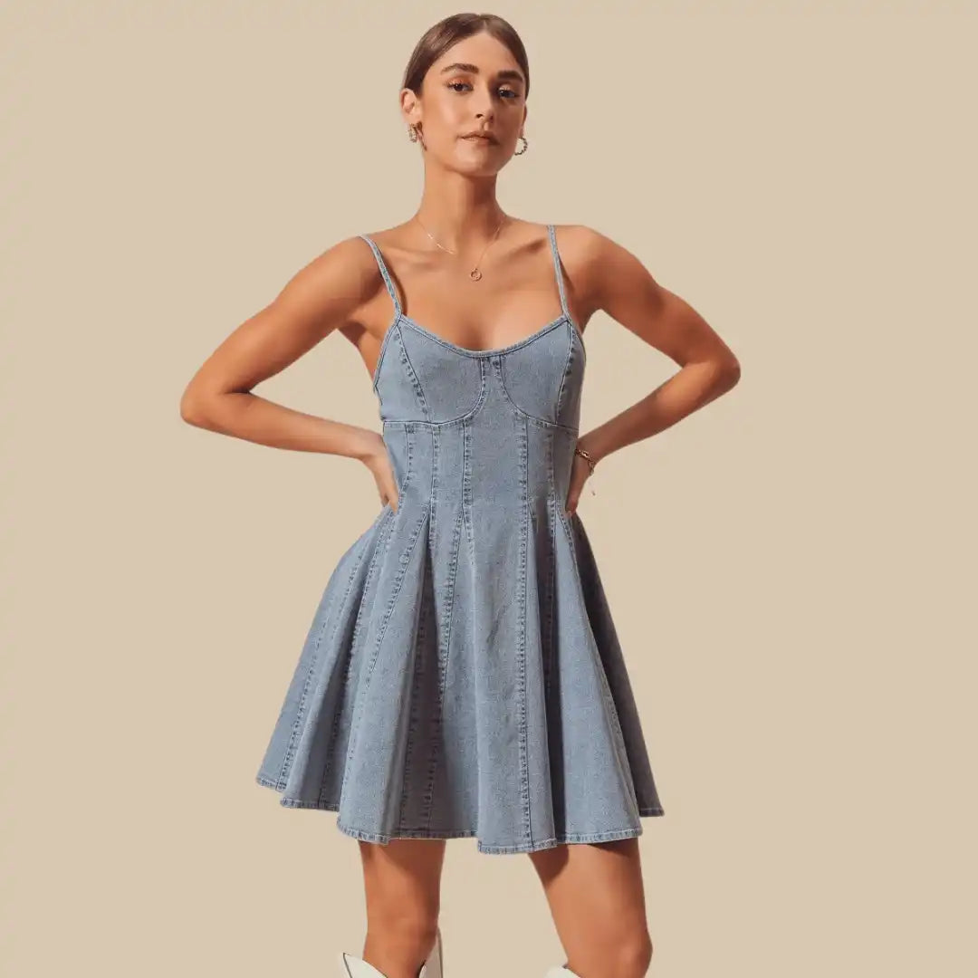 Light-wash denim mini dress with spaghetti straps and a flared skirt.