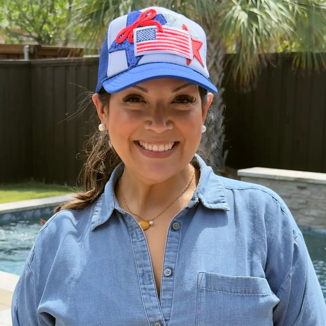 Blue and white trucker hat with red, white, and blue embroidered american flag patch and star design