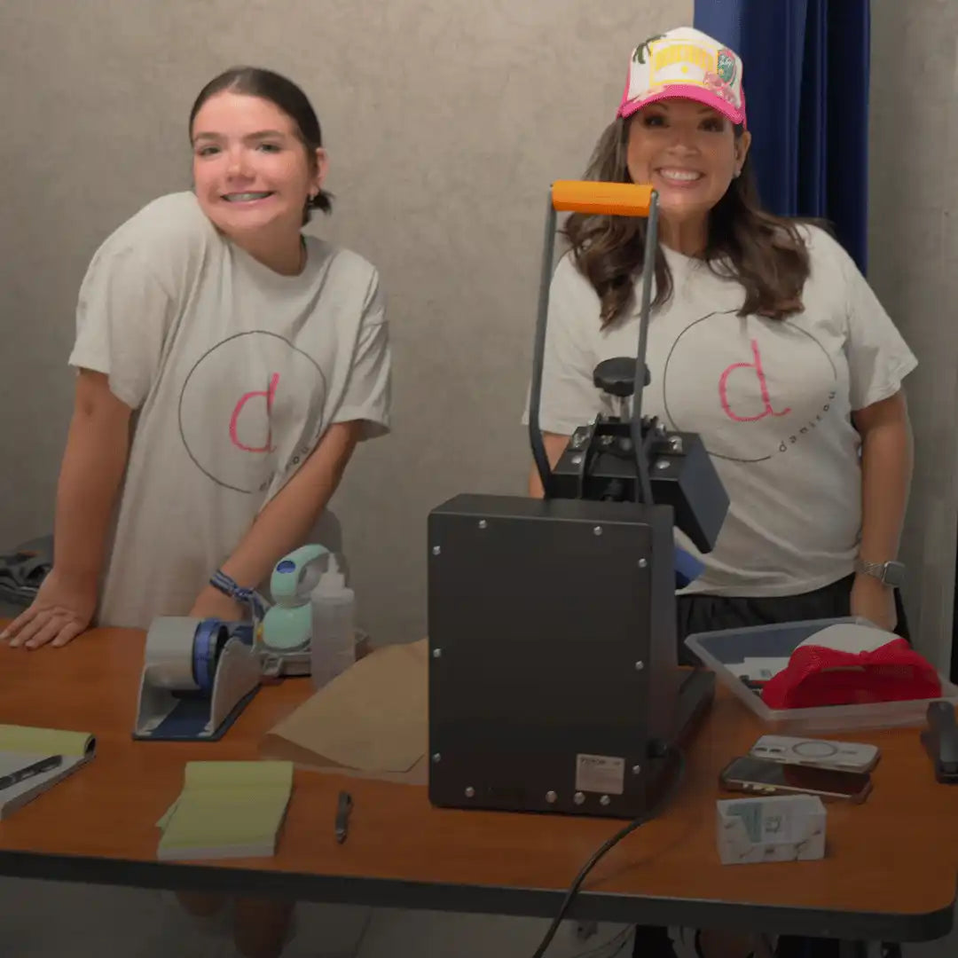 A heat press machine with an orange handle.
