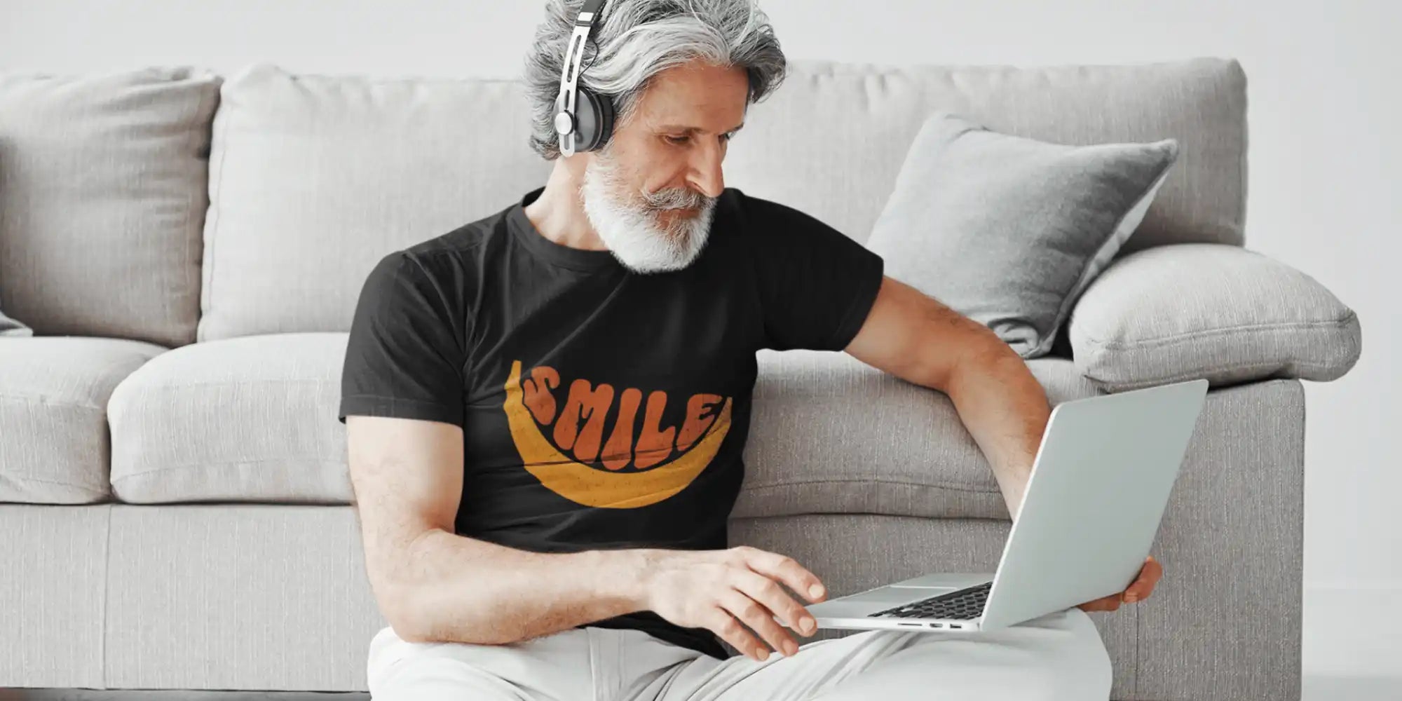 Man with headphones using laptop.
