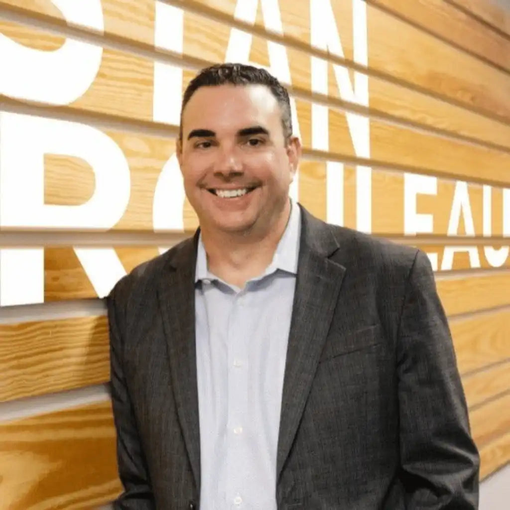 Smiling man in suit.