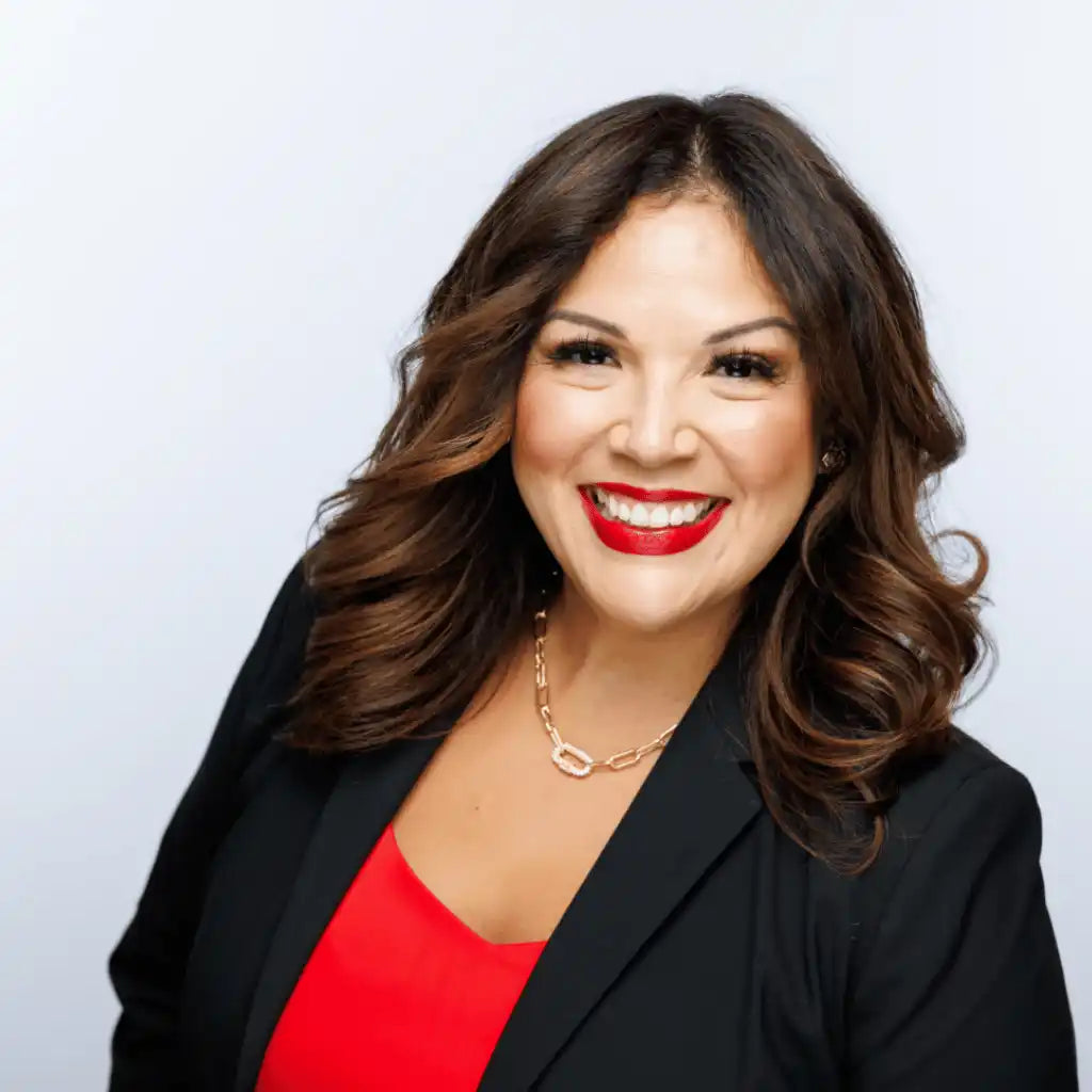 Smiling woman in a black blazer.